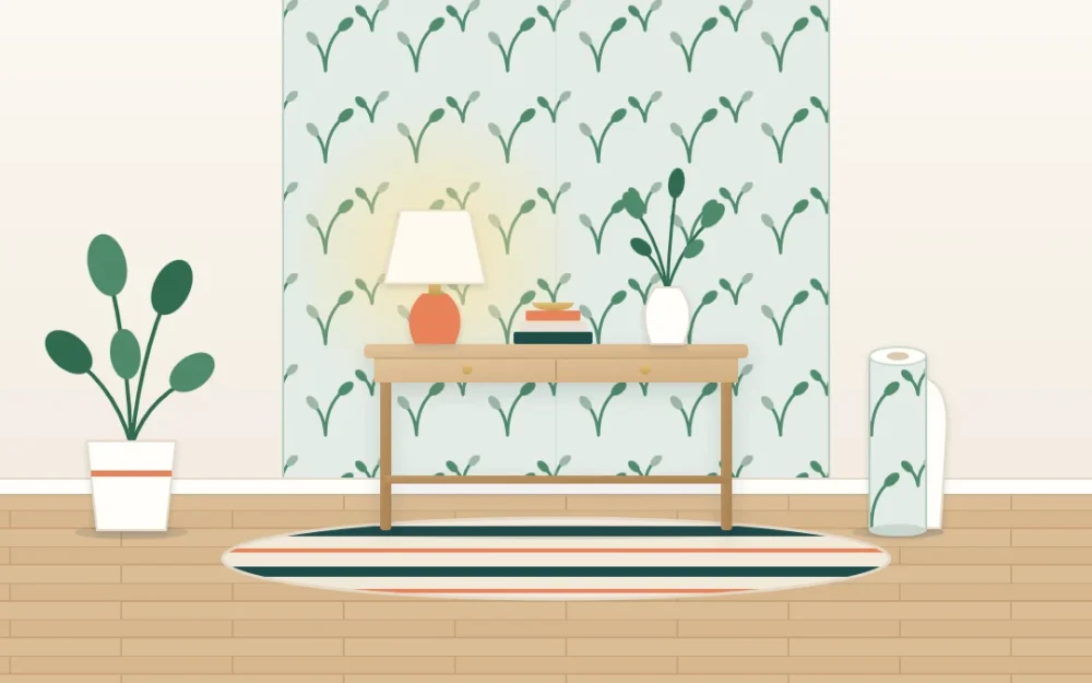 Apartment wall with one panel of botanical removable wallpaper behind a slim console holding a lamp and vase, the paper roll standing beside it